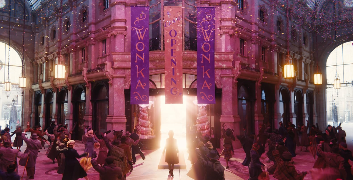 A still from the movie, Wonka. Willy Wonka walking into his chocolate shop. 